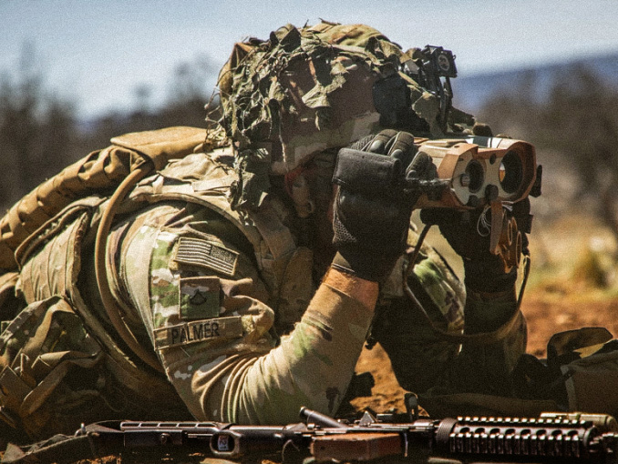 An Army calvary scout scans for enemy targets during a training