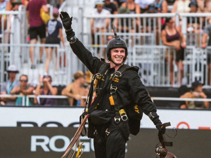 A Golden Knights skydiver waving to a crowd following a jump
