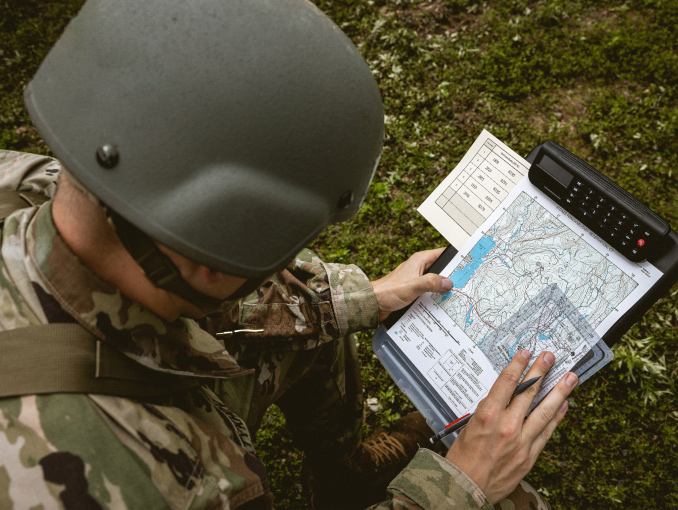 An Officer Candidate examines a topographical line map during a land navigation event