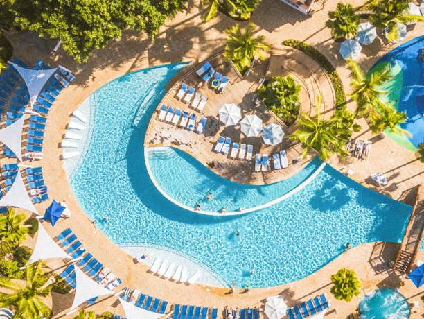 Bird’s-eye view of a pool and lounge chairs at a Hawaiian resort