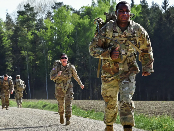 Soldiers complete a ruck march during a competition