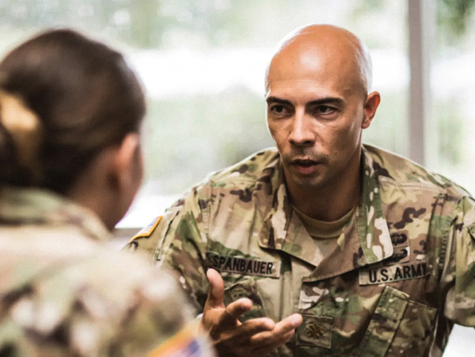 An Army clinical psychologist having a conversation with a Soldier
