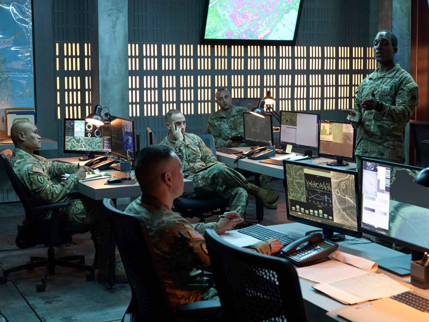 Soldiers in combat uniform working in a command center